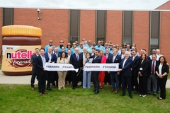 corporate group of people in front of large Nutella bottle model