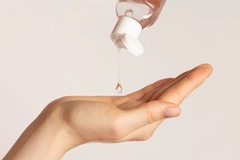 Image Lube being put into the palm of someone's hand.