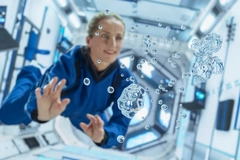 Astronaut playing with water in zero gravity Astronaut playing with water in zero gravity