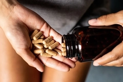 Image woman taking botanical ashwagandha supplement