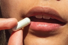 Image Woman taking a pill