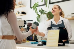 Image A person handing a cup from a customer