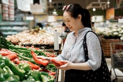 Image Woman Shopping for Peppers at Grocery Store