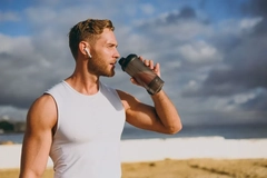 Image male athlete drinking protein shake
