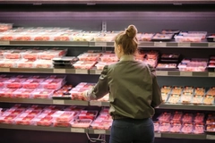 Woman shopping for meat.