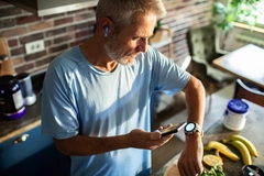 Image Man checking smartwatch after cooking