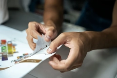Image Close-up of hands holding a piece of label