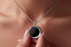 Image Two fingers holding the Gem pendant.