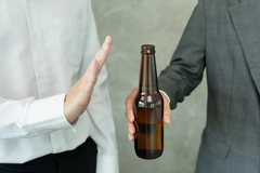 Image man rejects offer of beer bottle