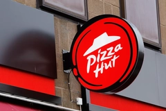 A Pizza Hut sign in front of a Pizza Hut Restaurant.