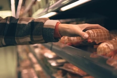 meat in supermarket shelf hand picking up packed meat in supermarket