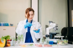 female scientist working in lab with food samples
