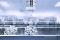 Machine filling supplement bottles