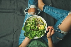 Woman eating dark leafy greens salad