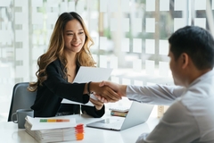 woman shaking hands with man