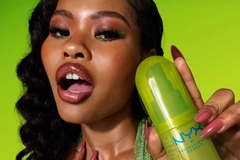 Image A woman holding a NYX fragrance.