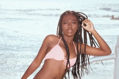 Image Woman in a swimsuit standing by the beach