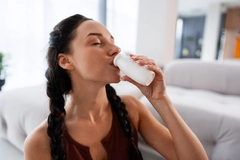 Image Happy woman drinking yogurt
