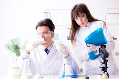 scientists testing food sample male and female scientist testing food in lab