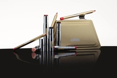 Image A group of makeup products on a black surface