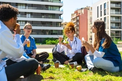 Image Medical students and doctors enjoying healthy lunch outdoors