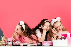 Image Three young girls doing their makeup.