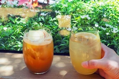 hand holding a glass of sparkling yuzu drink hand holding a glass of sparkling yuzu drink