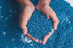 Image A person holds bioplastic pellets