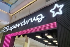 Image A Superdrug sign on the outside of a store.