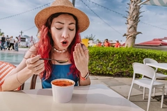 woman on beach reacting to hot spicy soup