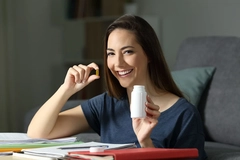 Woman taking brain health supplements Woman taking brain health supplements