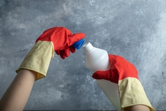 someone opening chemical bottle with gloves on